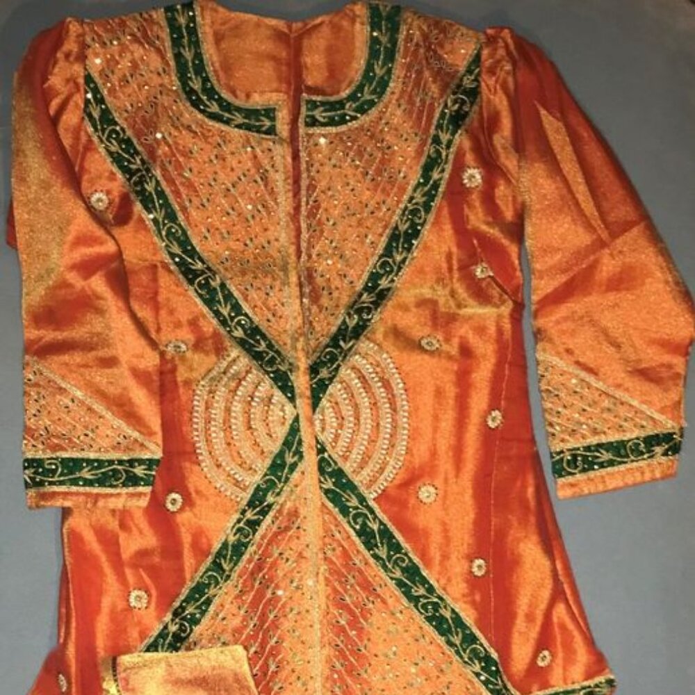 Beautiful Copper Lehenga with Green accents and pearl / zari styling.
